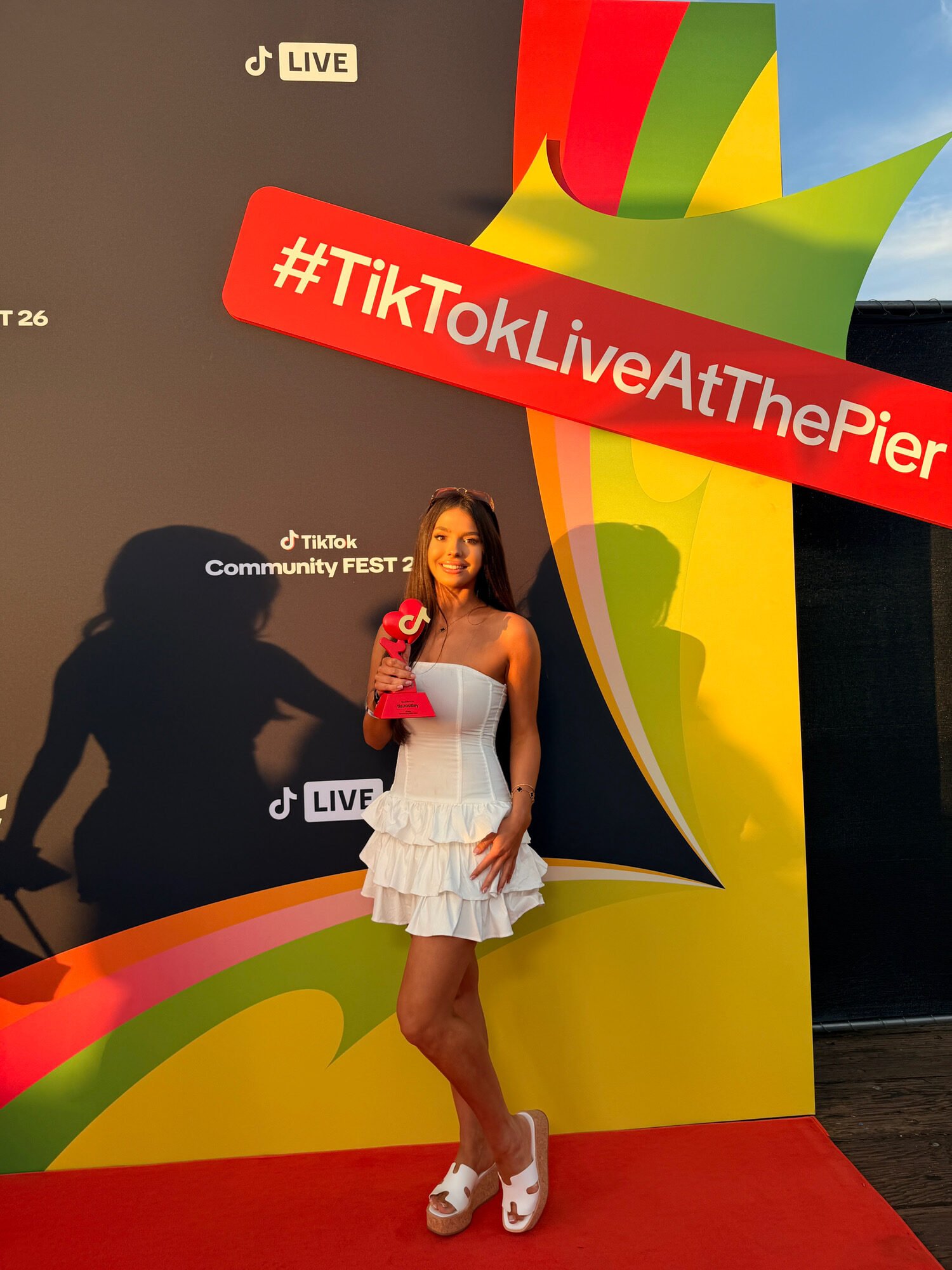 Tia Routley holding her TikTok Community Fest 26 Gold League trophy